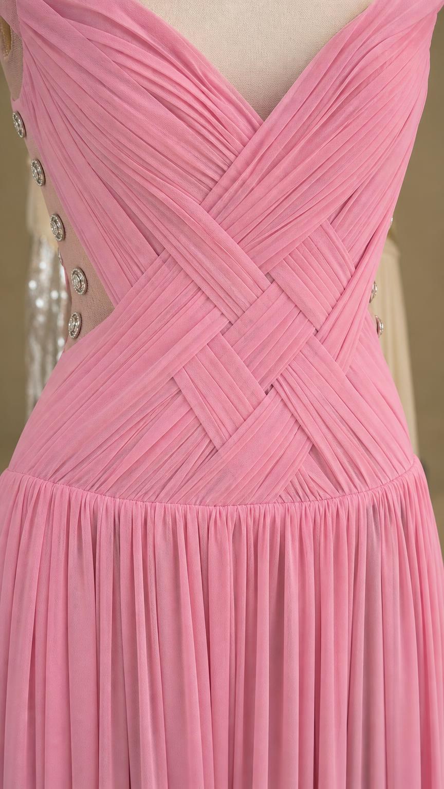Close-up of pink bodice with crisscross pleating and button details