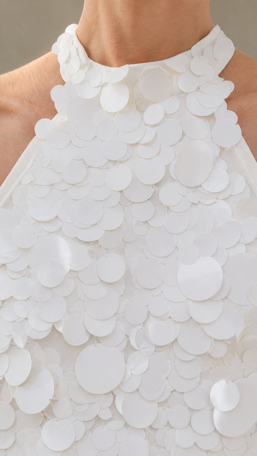 Close-up detail of halter neckline and 3D floral appliques in White