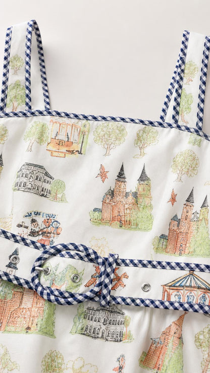 Close-up detail of fabric, illustrated print, gingham straps, and belted waist