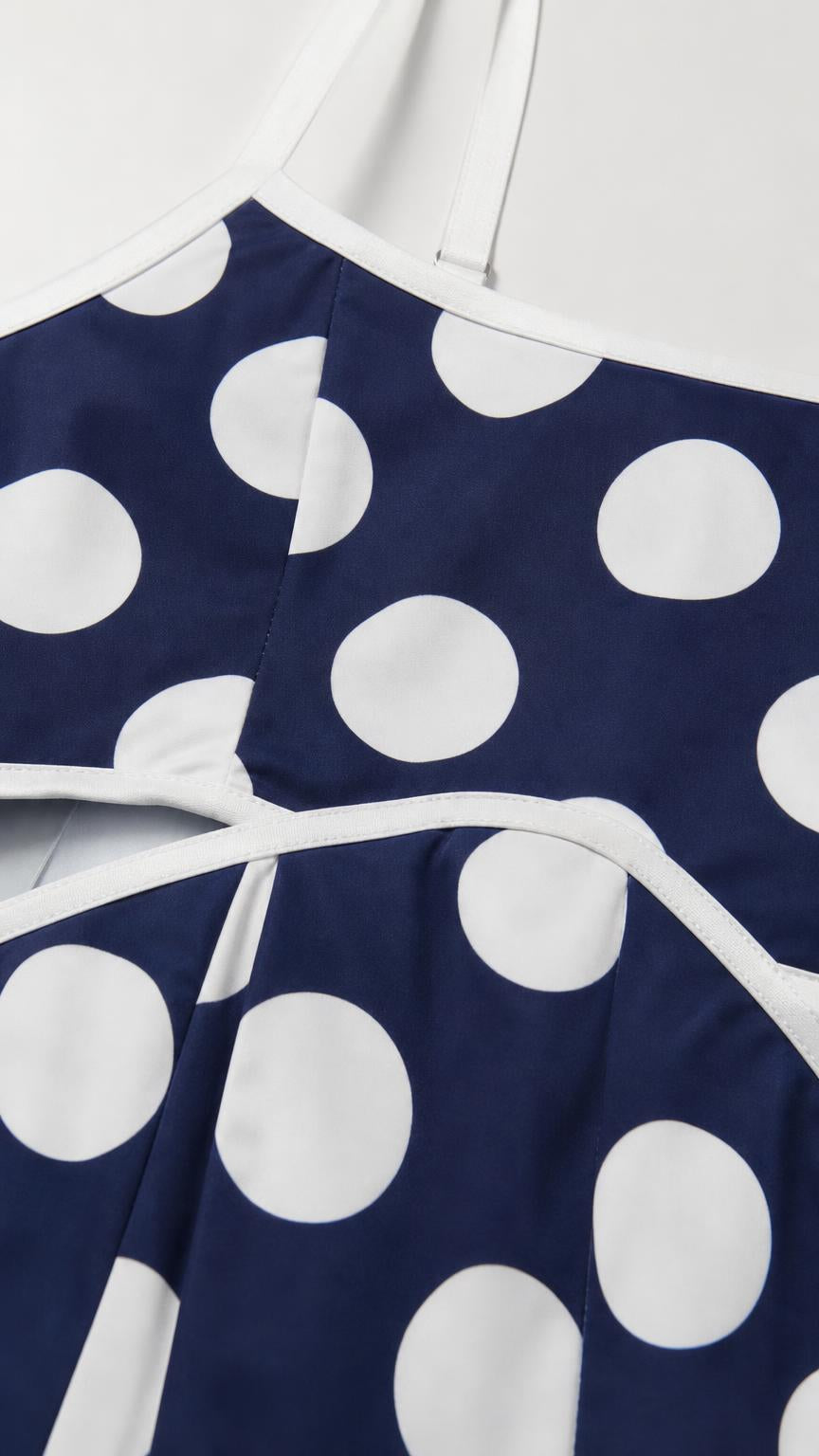 Close up of neckline and strap detail of polka dot dress