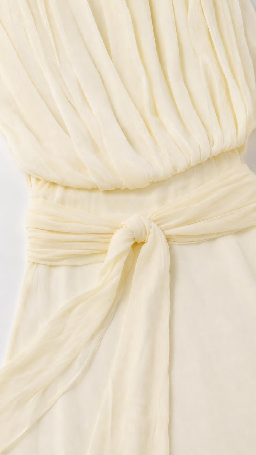 Close-up of bodice pleating and waist tie on yellow dress