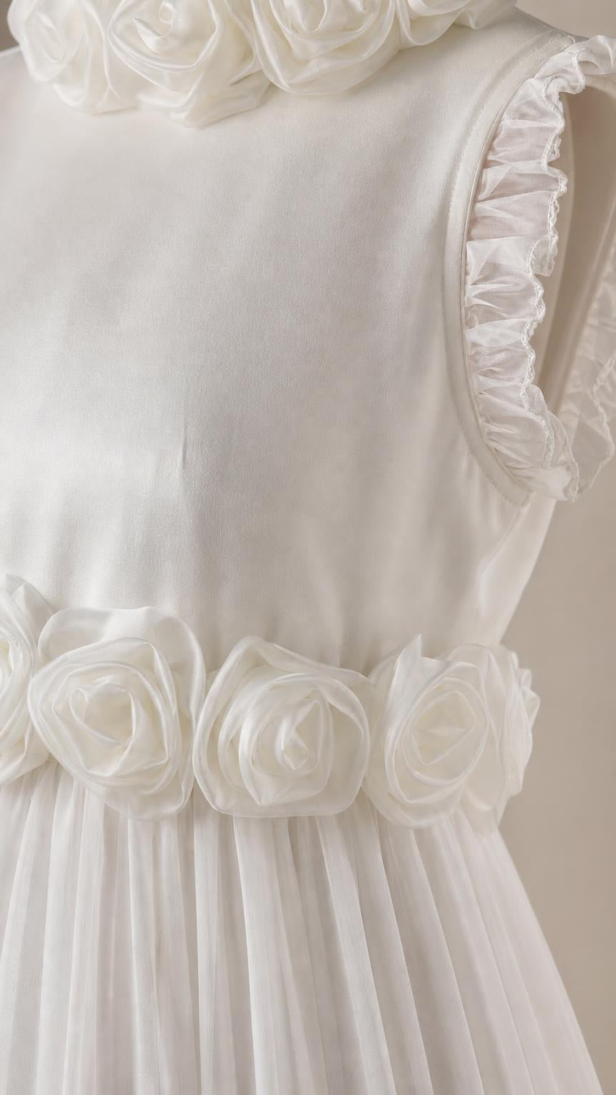 Close up of 3D rosette waist detail and ruffled shoulder