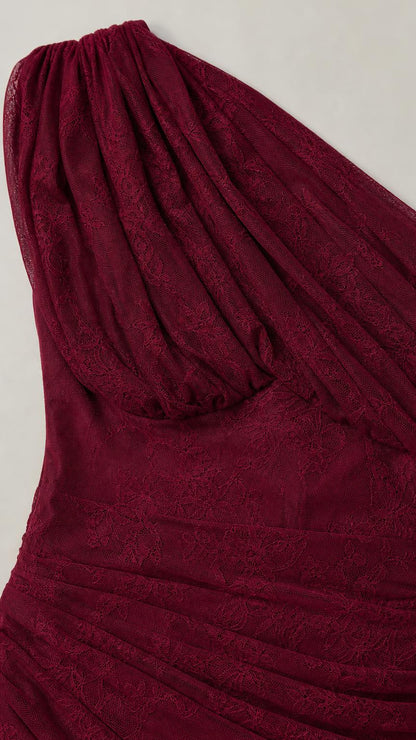 Close-up detail of burgundy lace texture and ruching