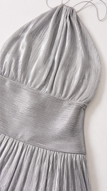 Close-up detail of pleated fabric and bodice on silver dress