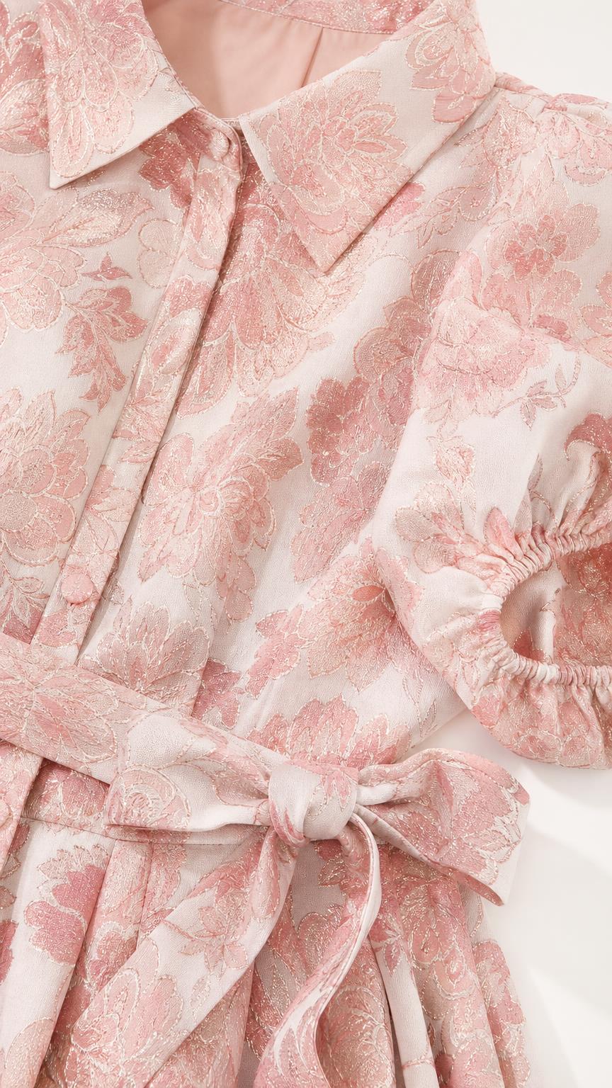 Close-up detail of collar, button placket, and self-tie belt on pink floral dress