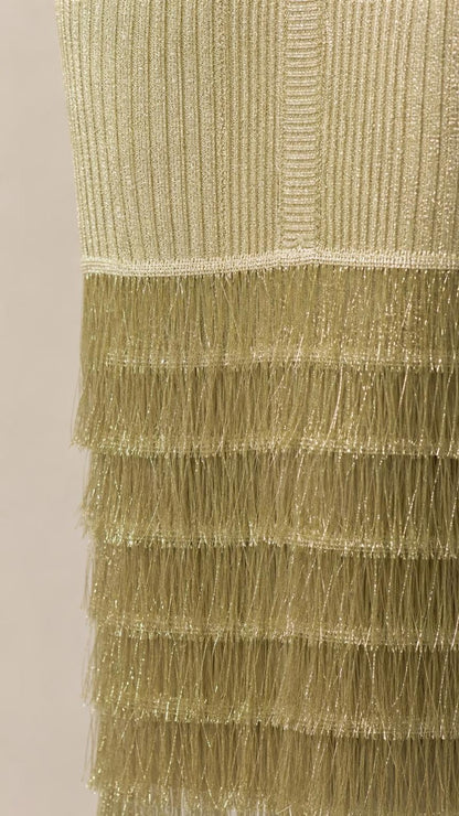 Close-up detail of tiered fringe hem on olive midi dress