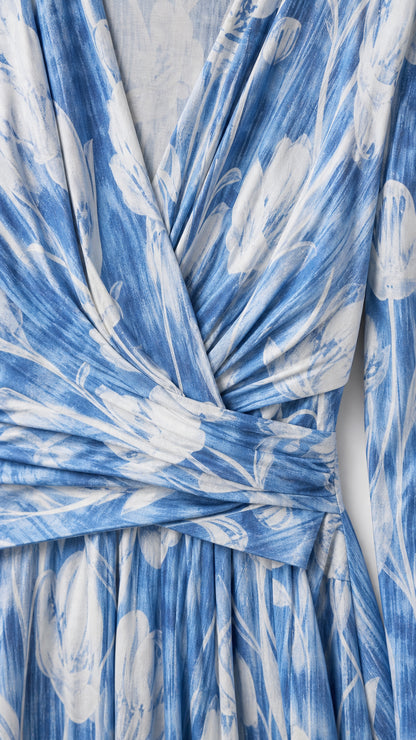 Close-up of fabric and wrap V-neck detail on blue floral dress