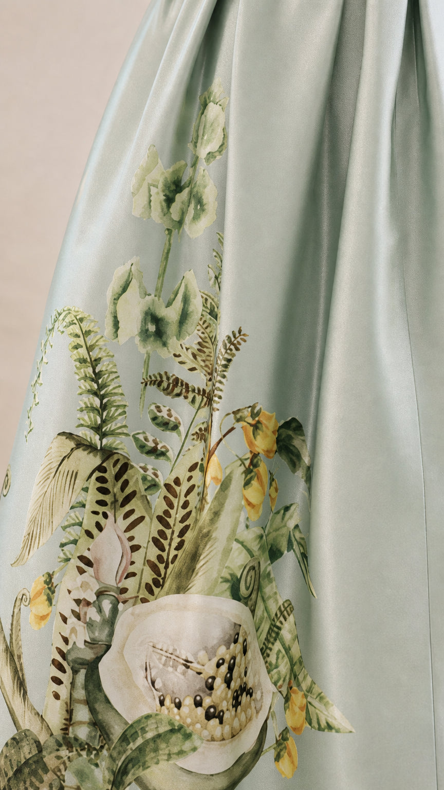 Close-up detail of botanical embroidery on dress skirt