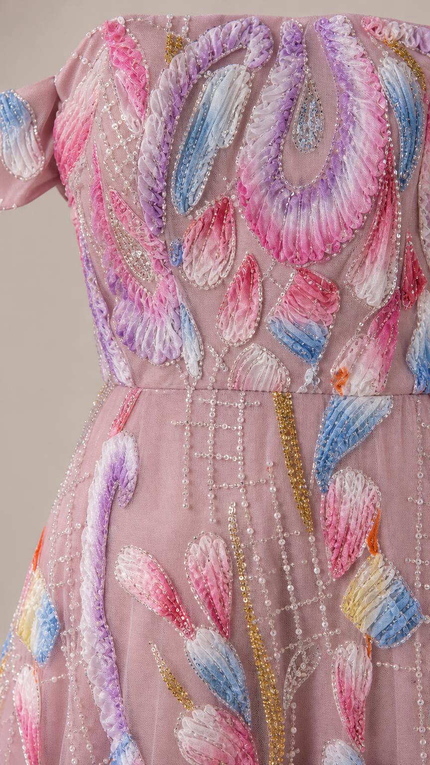 Close-up detail of embroidery on pink evening gown