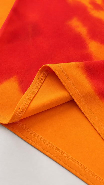 Close-up of fabric texture and hemline of orange dress