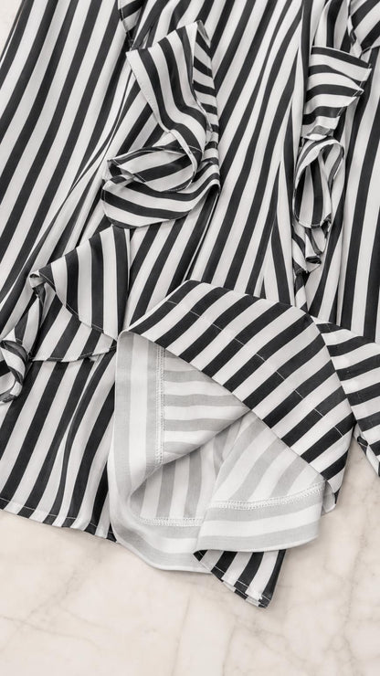 Close-up detail of fabric, ruffles, and stripes