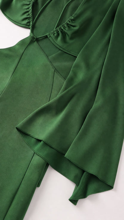Close-up detail of green satin fabric and sleeve construction