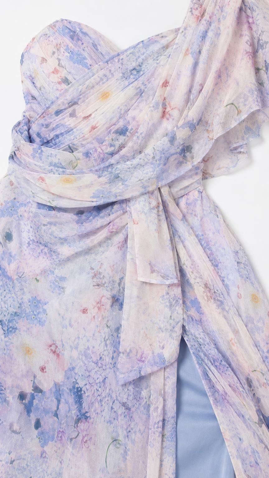 Close-up detail of draped bodice and fabric texture on blue floral dress