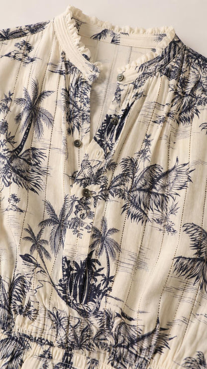 Close-up detail of the ruffled collar, buttons, and fabric texture on ivory romper