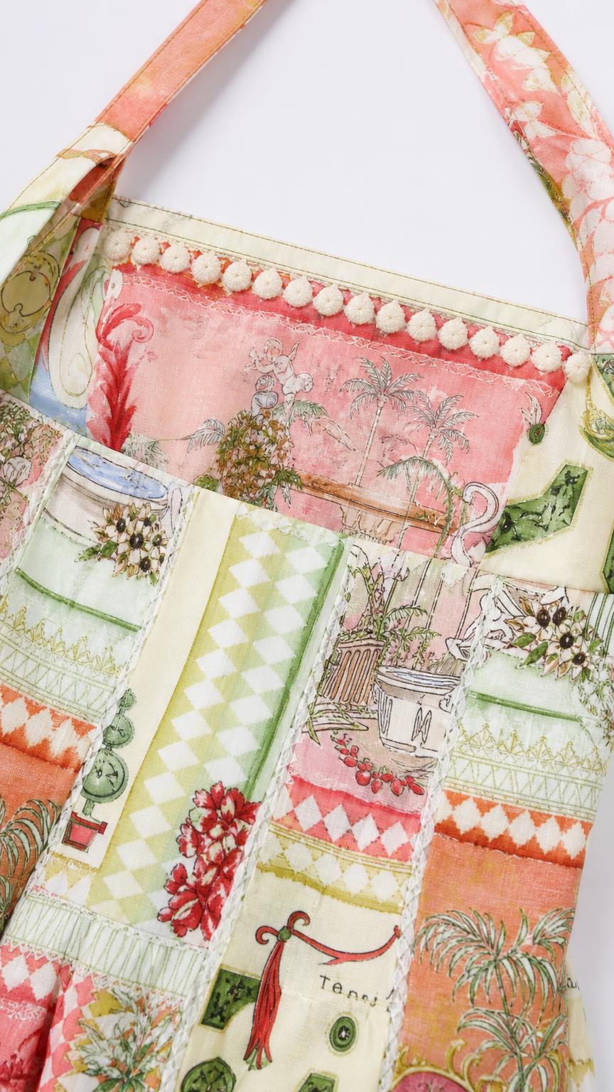 Close up detail of patchwork print and trim on dress bodice