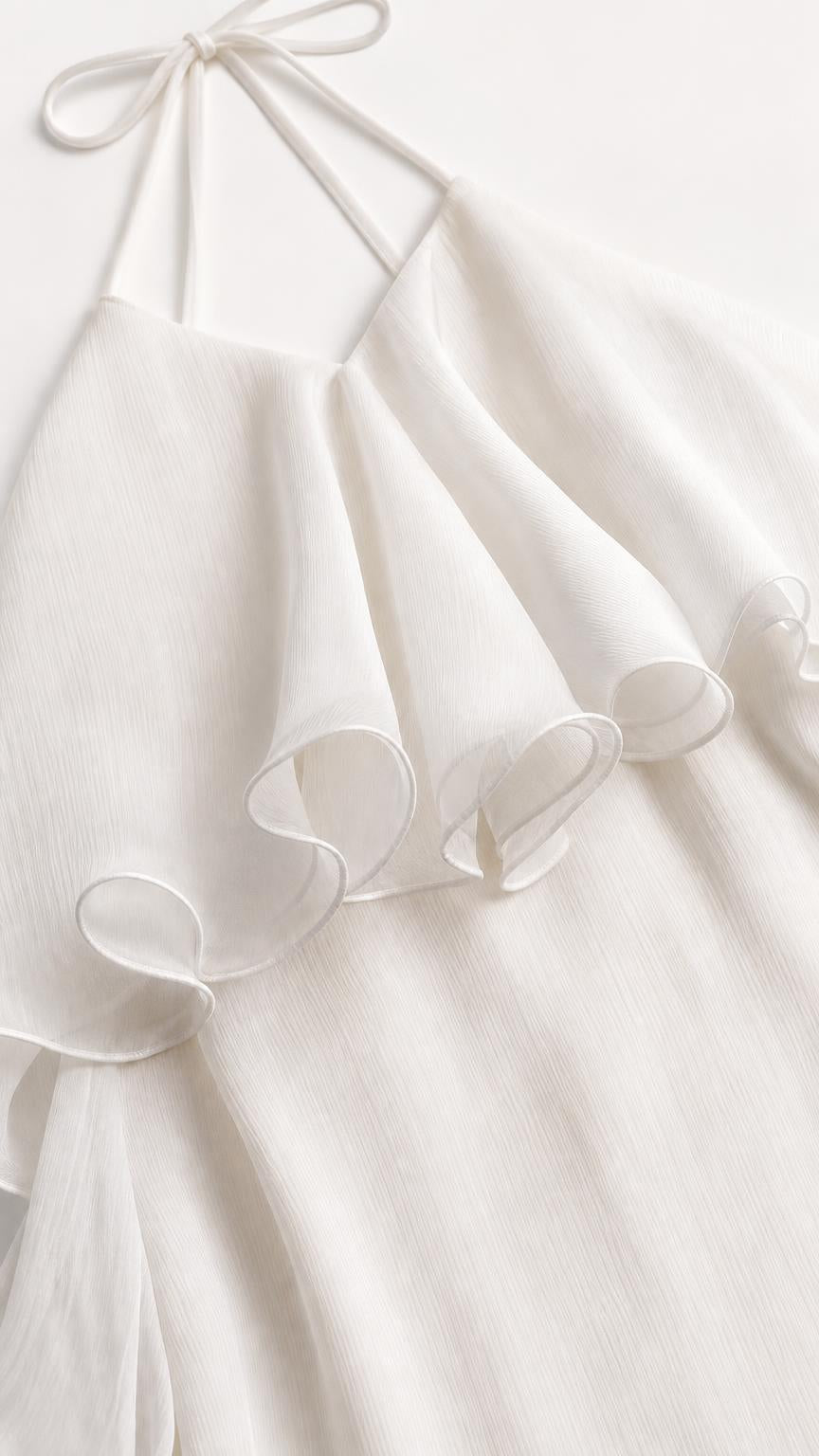 Close up of White dress halter tie and ruffle detail