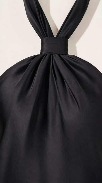 Close-up detail of halter neckline and gathered satin fabric