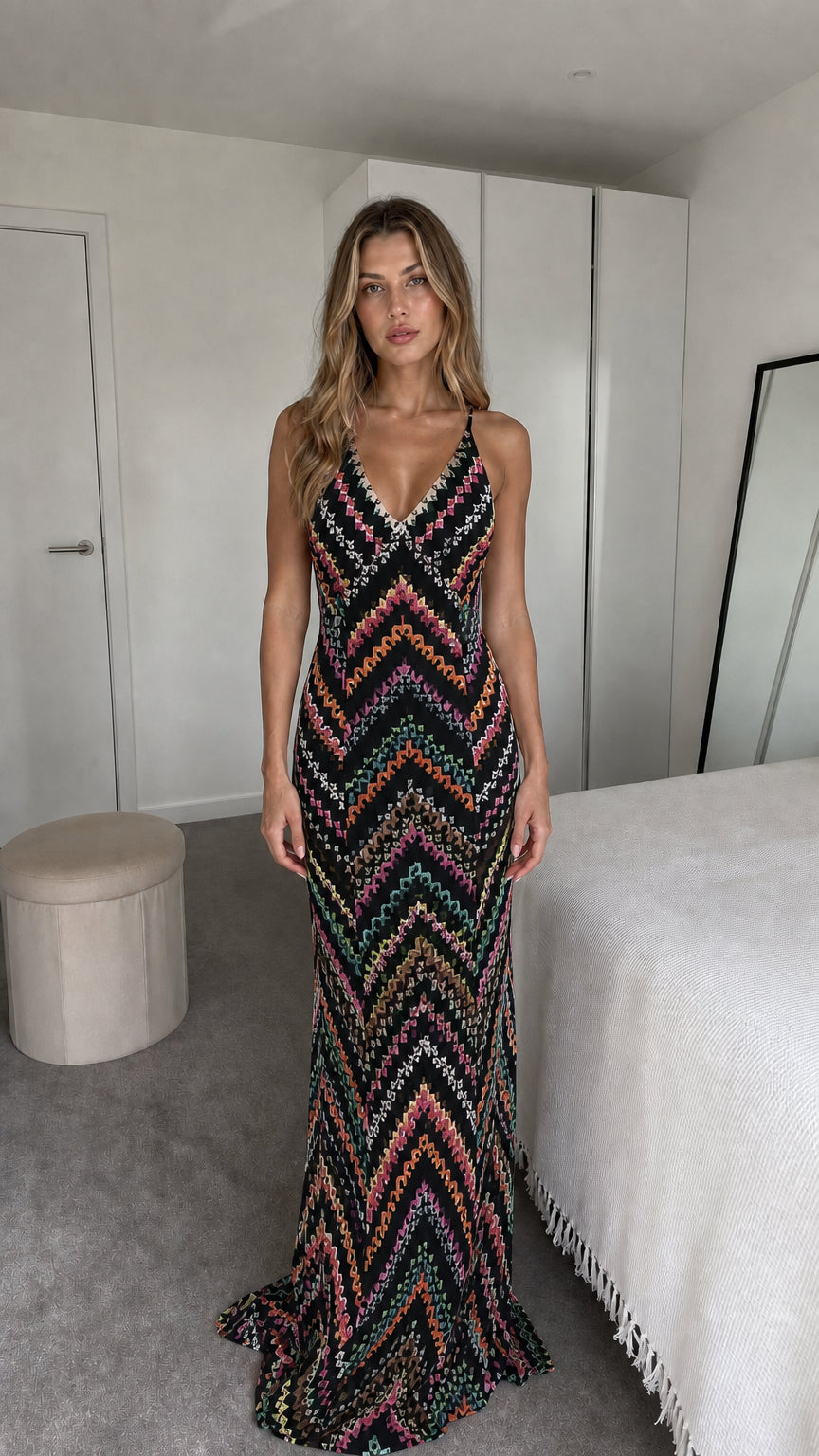 Front view of model wearing black chevron maxi dress