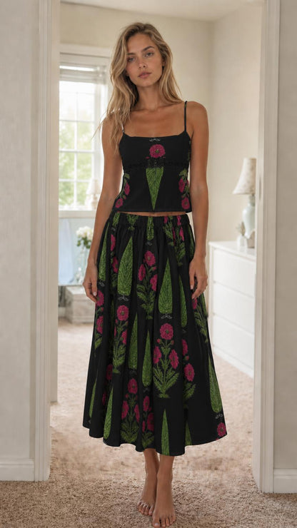 Woman wearing black floral print cami top and midi skirt set