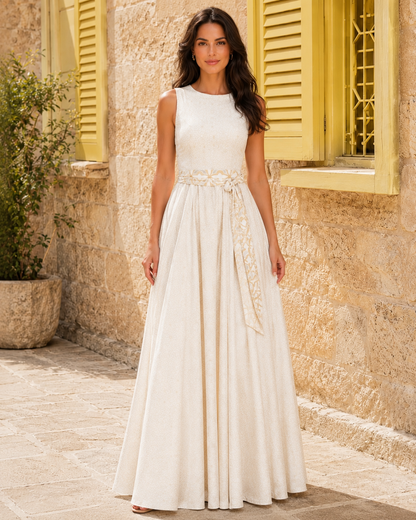 Front view of ivory sleeveless maxi dress with waist sash and full skirt