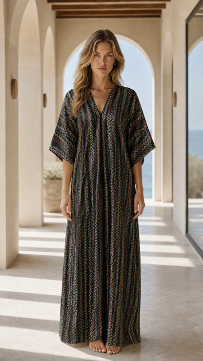 Front view of woman wearing black chevron kaftan dress