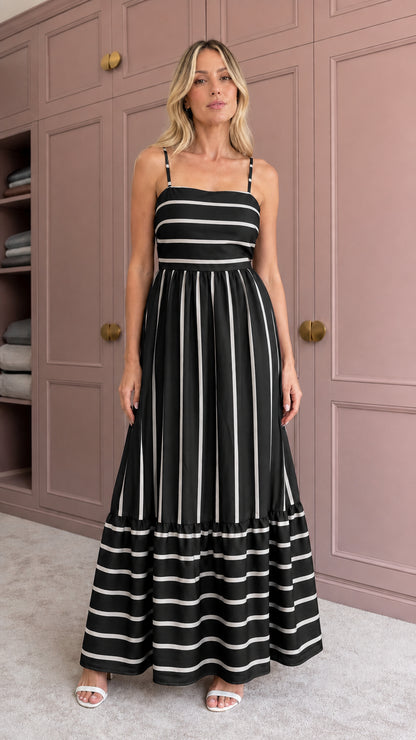 Woman wearing black striped tiered maxi dress