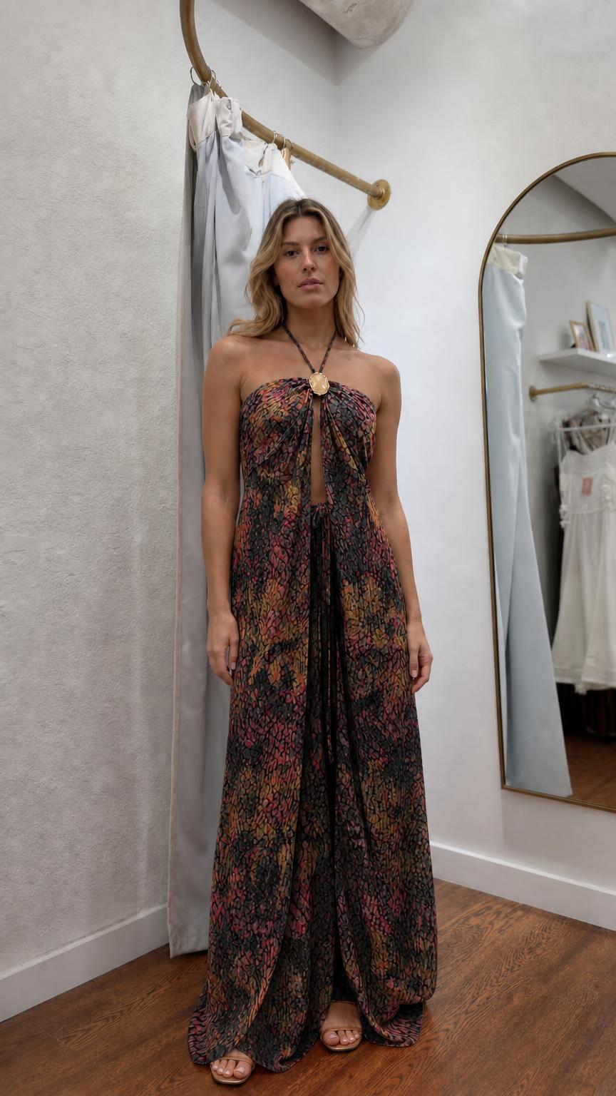 Model wearing black patterned halter maxi dress