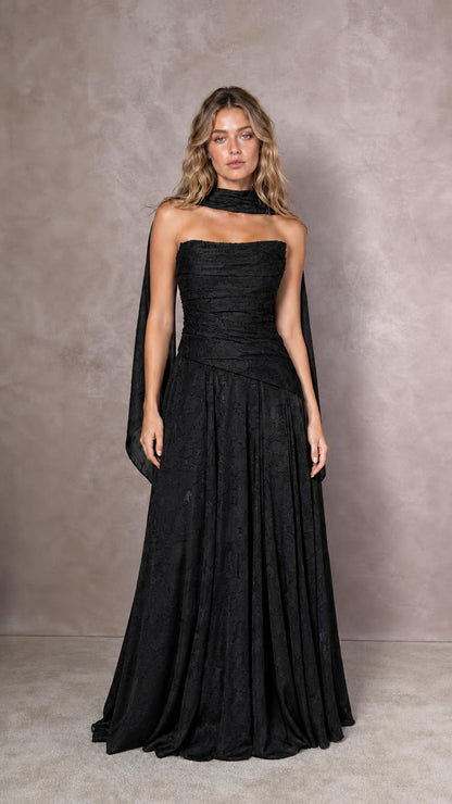 Front view of model wearing black strapless evening dress