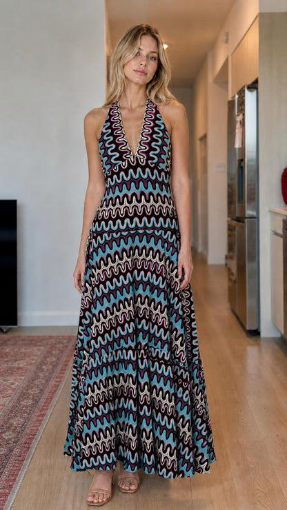 Model wearing black multi wave pattern halter maxi dress
