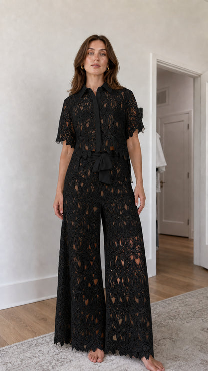 Woman wearing black floral lace shirt and wide-leg pants set