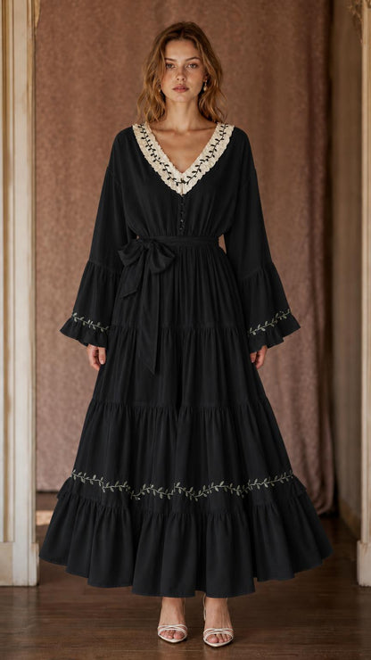 Black women's tiered maxi dress with V-neckline, botanical trim, bell sleeves, and side tie