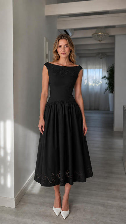 Full view of woman wearing black boatneck midi dress
