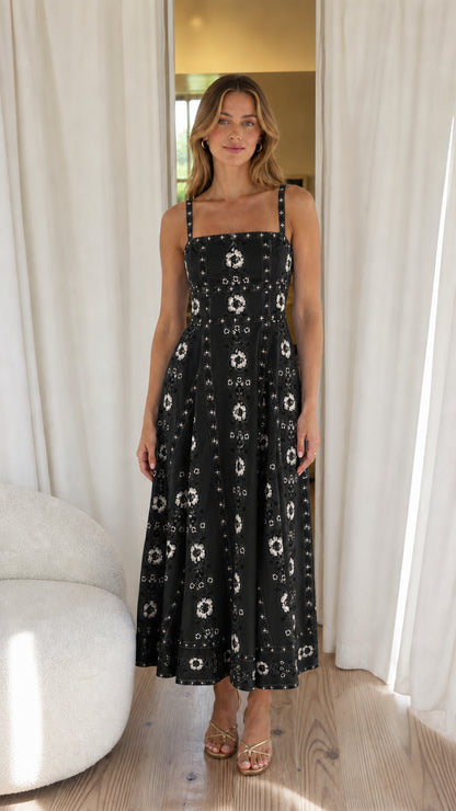 Woman wearing black floral embroidered midi dress