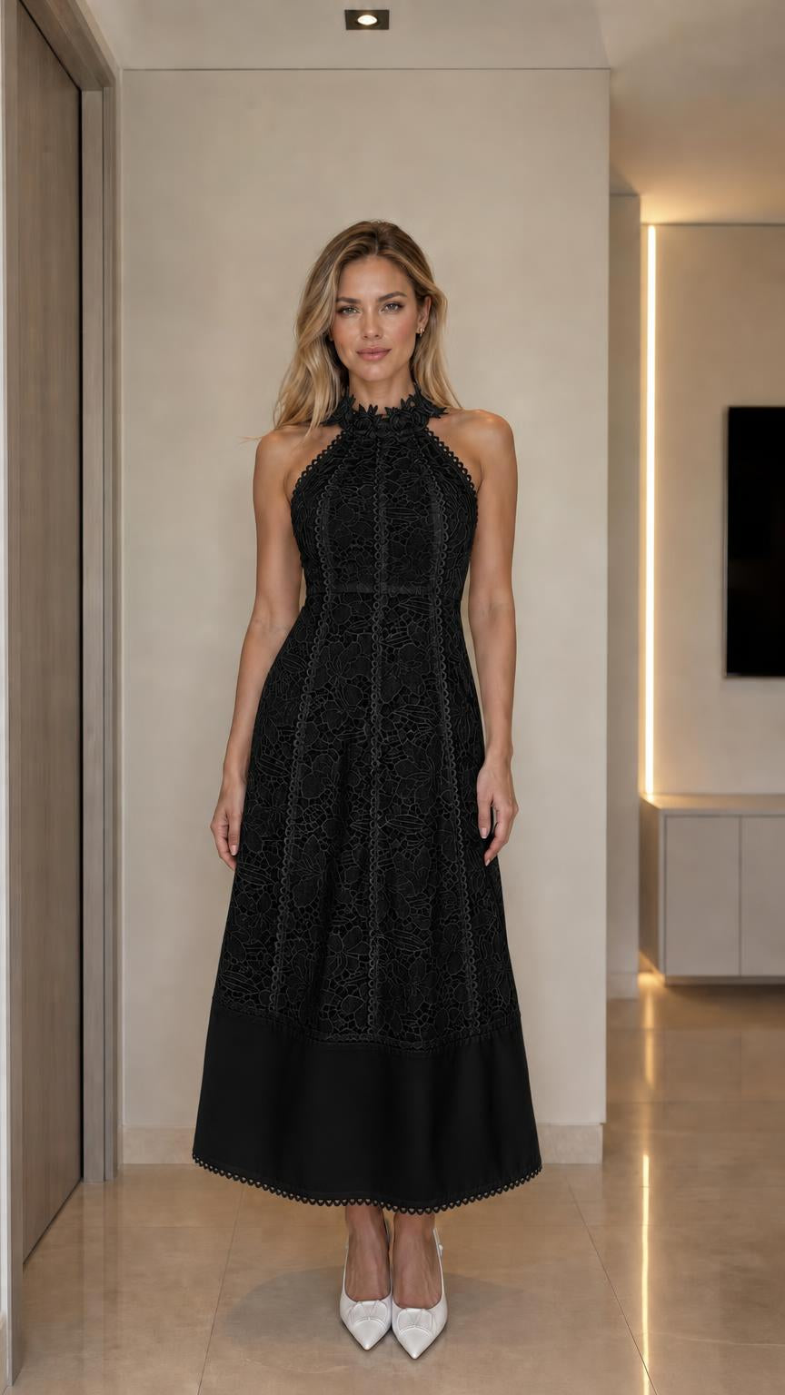Front view of woman wearing black halter neck lace midi dress