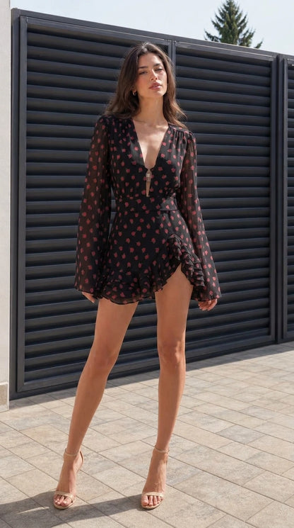 Full front view of model wearing black floral mini dress