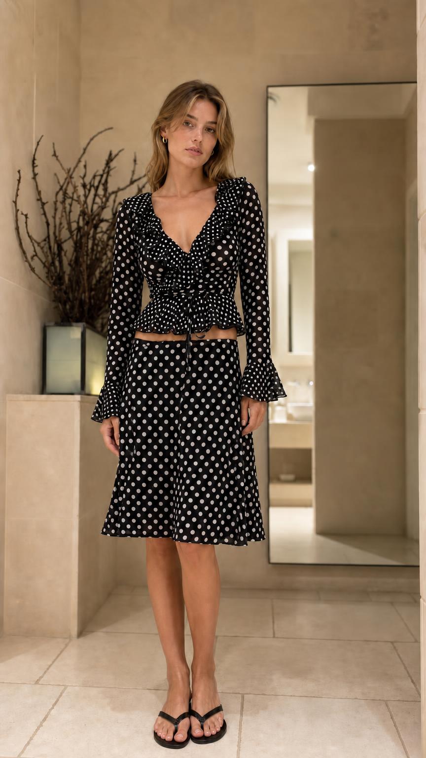 Front view of model wearing Black polka dot matching set