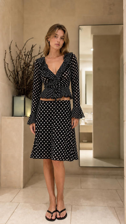 Front view of model wearing Black polka dot matching set