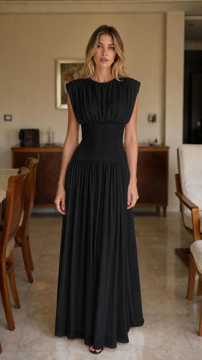 Front view of woman wearing black pleated maxi dress