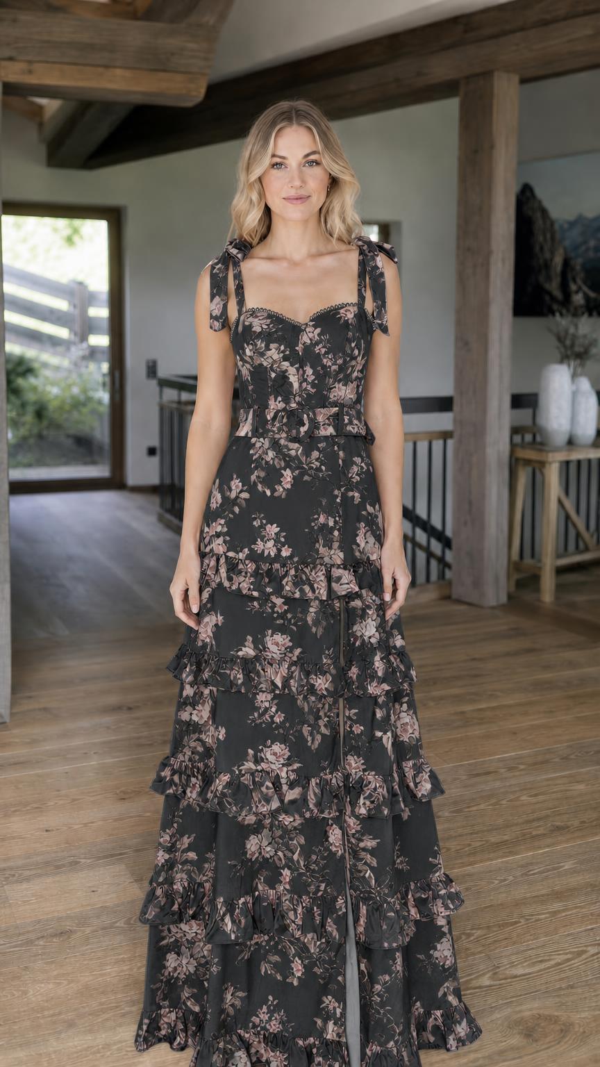 Model wearing black floral print tiered maxi dress