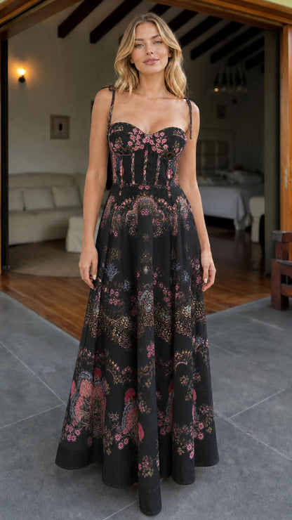 Model wearing black floral print corset maxi dress