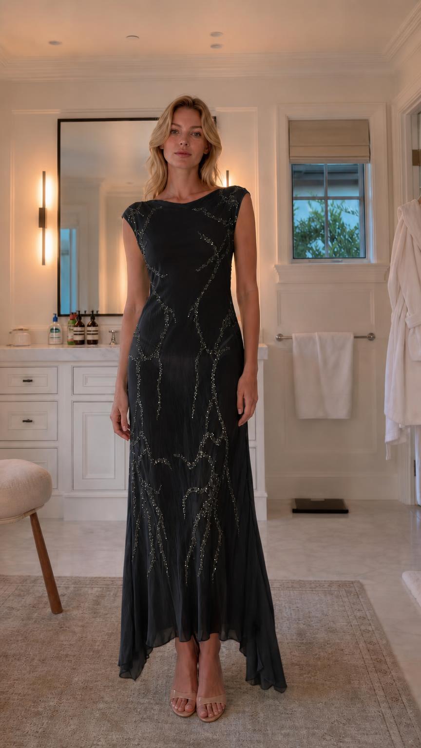 Front view of model wearing black sequin maxi dress