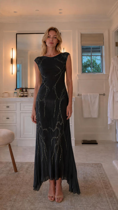 Front view of model wearing black sequin maxi dress