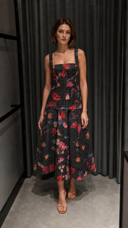 Front view of black floral tweed top and midi skirt set