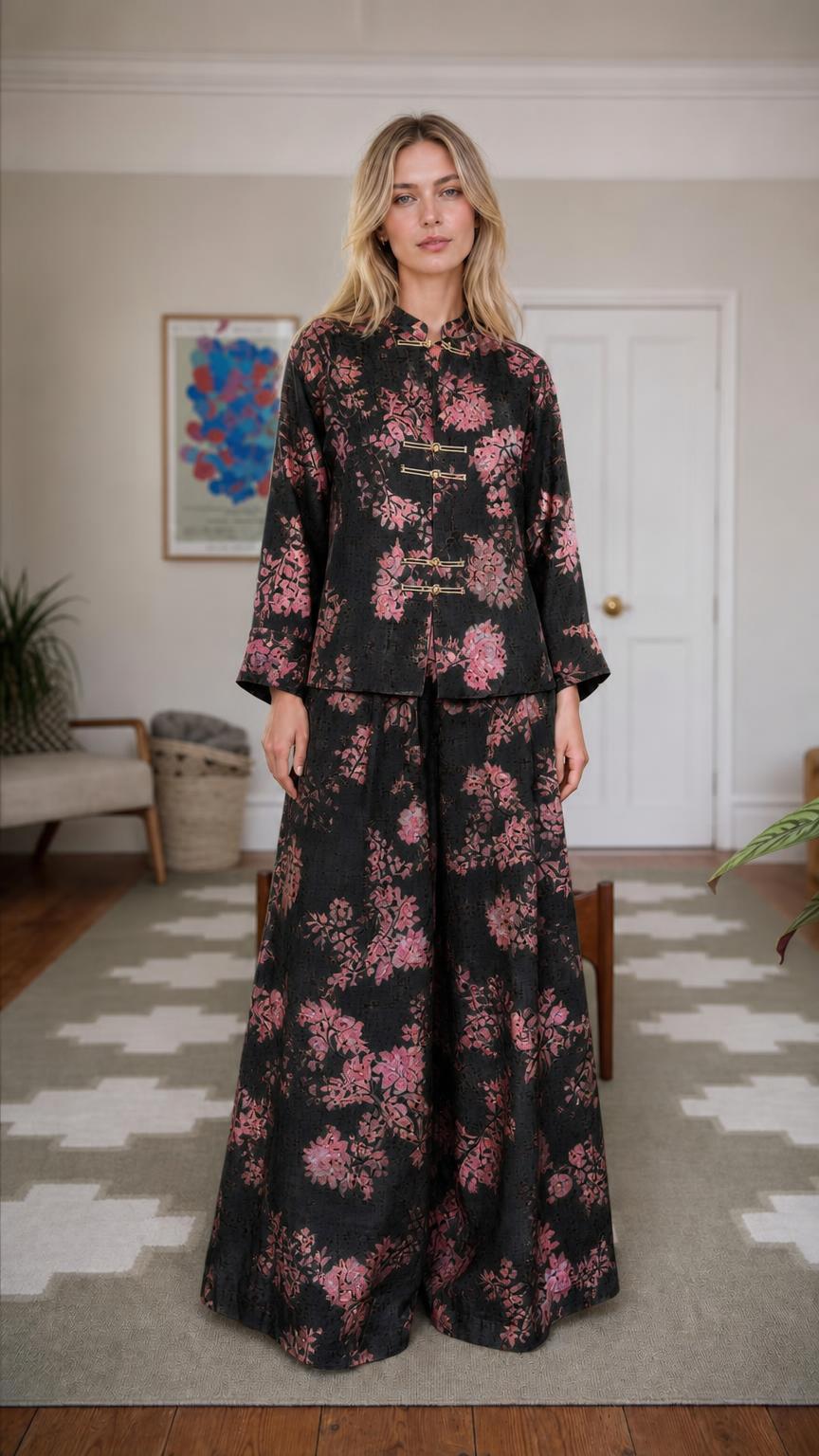 Front view of woman wearing black floral brocade set
