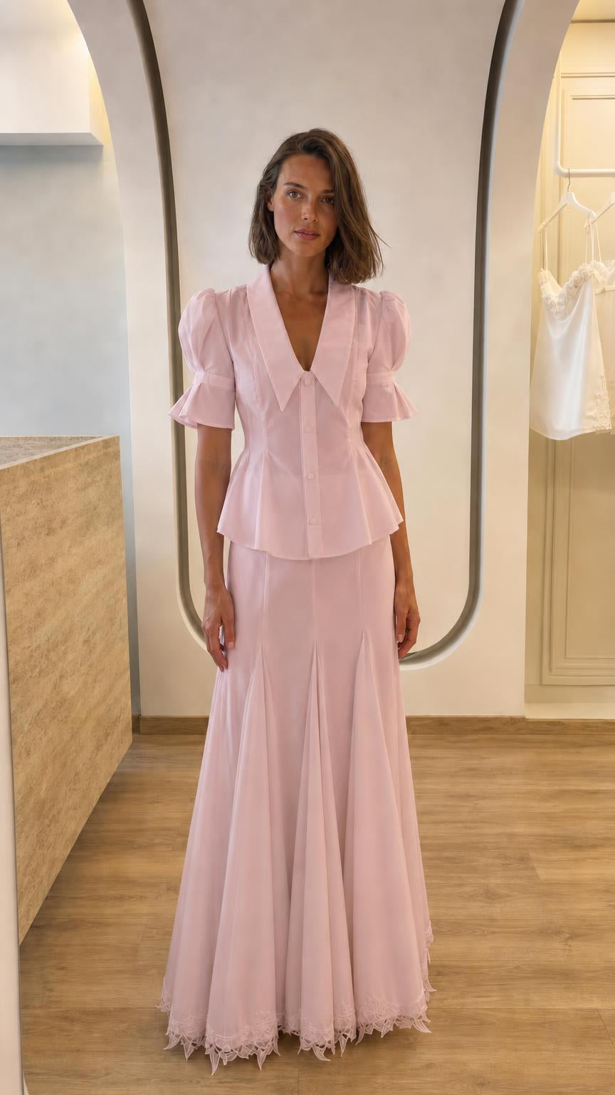 Front view of woman in pink two-piece peplum top and maxi skirt set