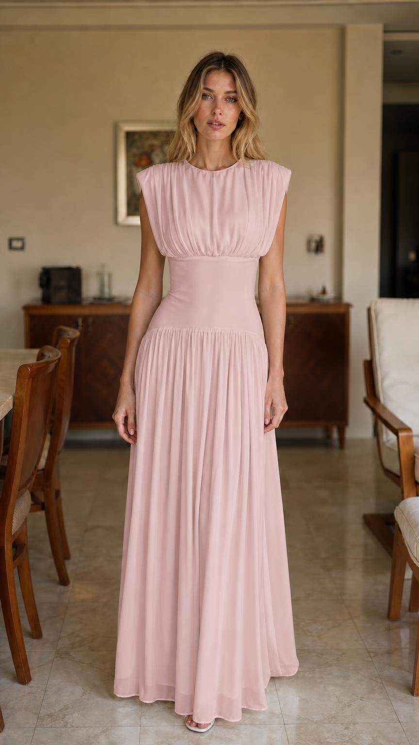 Front view of woman wearing pink pleated maxi dress
