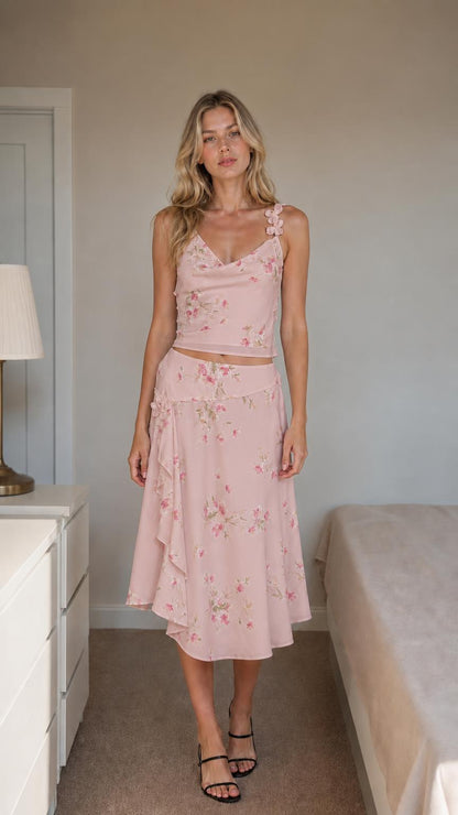 Front view of pink floral two-piece set on model