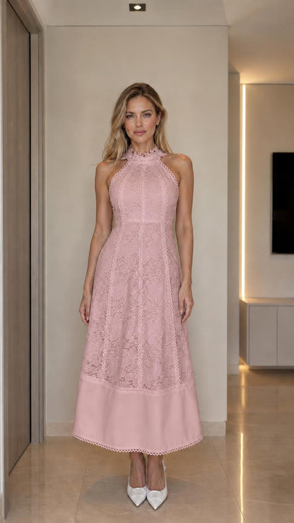 Front view of woman wearing pink halter neck lace midi dress
