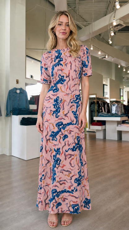 Front view of model wearing pink abstract print maxi dress