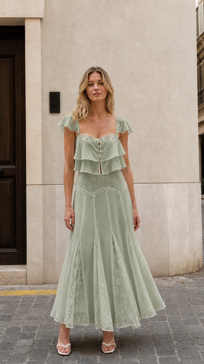 Front view of woman wearing sage green ruffled two-piece maxi set